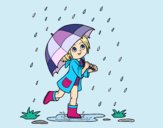 Niña con paraguas bajo la lluvia