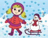 Niña con trineo y muñeco de nieve